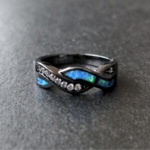 New braided ring with crystals and inlaid opals, black carbon style